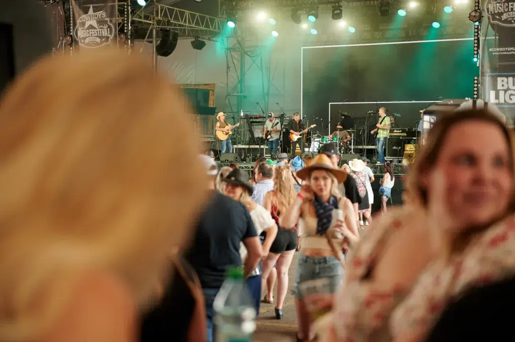 A crowd in front of a band playing on stage for an event in Alberta.