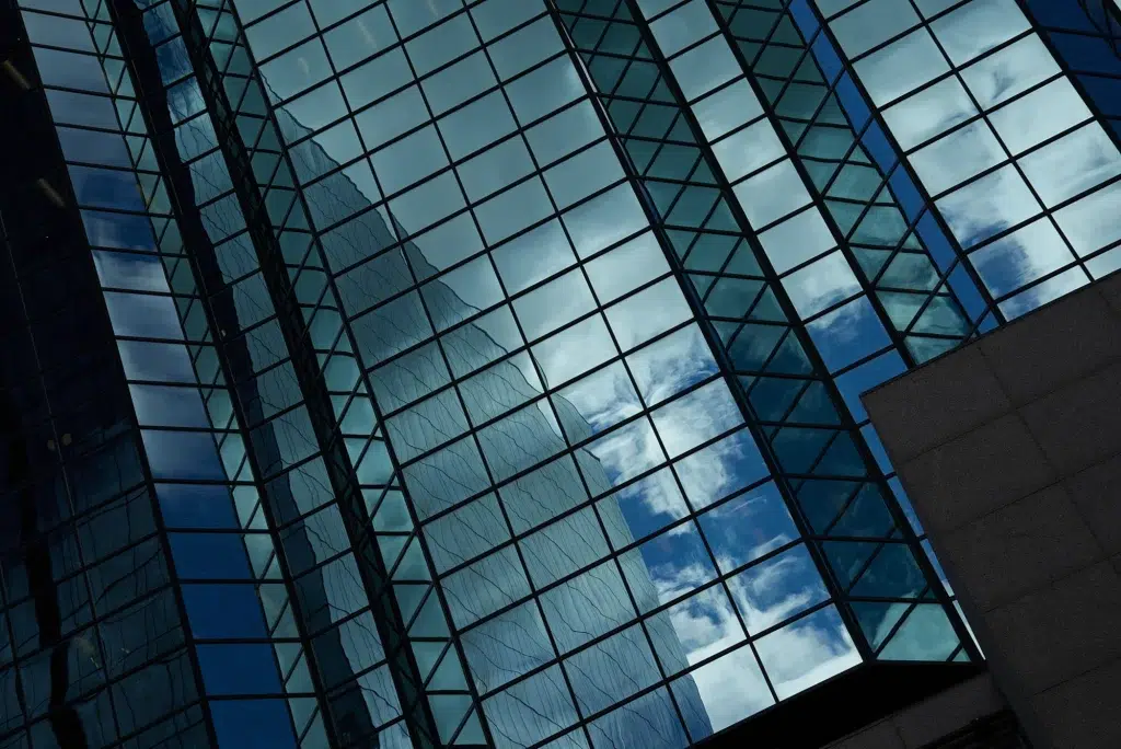 A tall building in downtown Calgary with mirrored windows, recorded as part of a video for a development company.