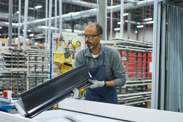 A person handles a product in a facility during an educational video shoot.