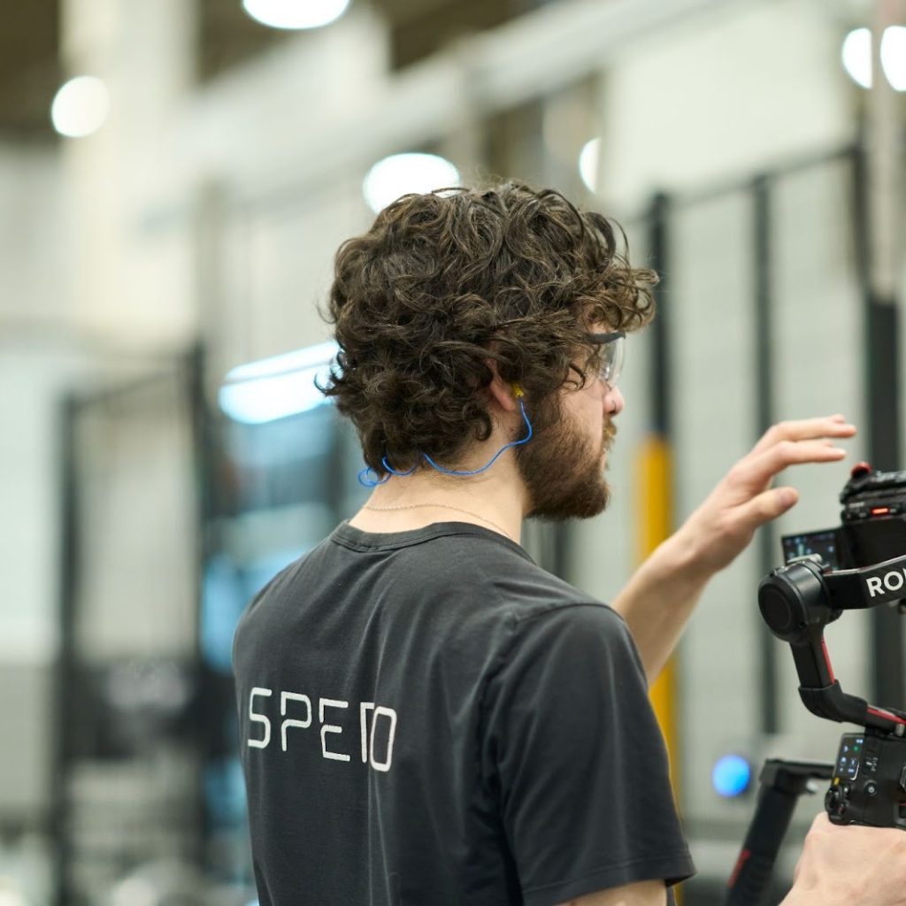 A videographer adjusting their camera behind the scenes of a video shoot in Calgary.