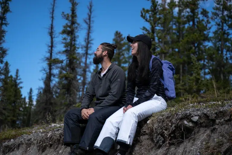 Two people sit on a hill to record an authentic video for a 2026 campaign.