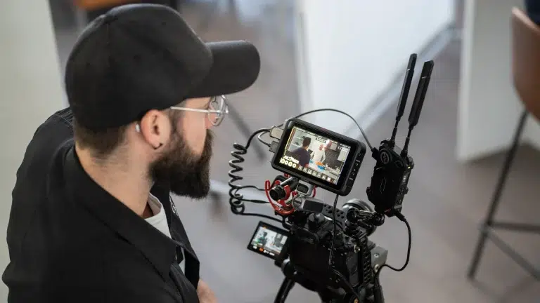 A videographer watches the camera screen during a video shoot in Calgary.