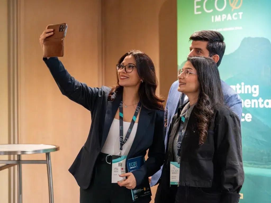 People take a selfie at a marketing conference as part of their b2b video marketing strategy.