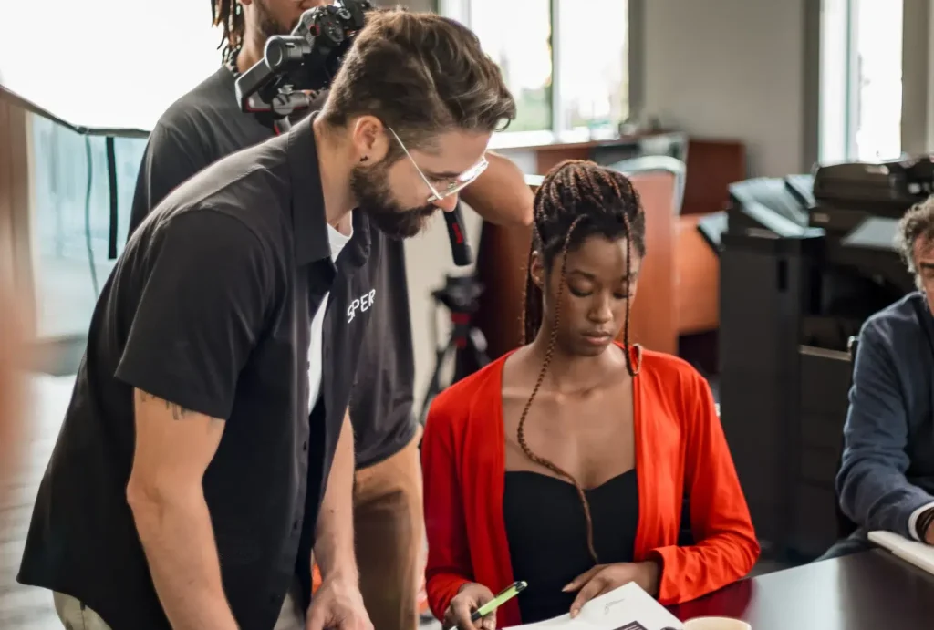 A videographer guides an actor during a corporate video shoot in Calgary.