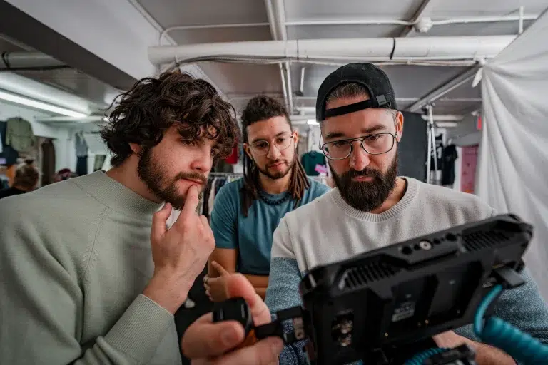 A team of videographers view video playback during a brand video in Calgary.
