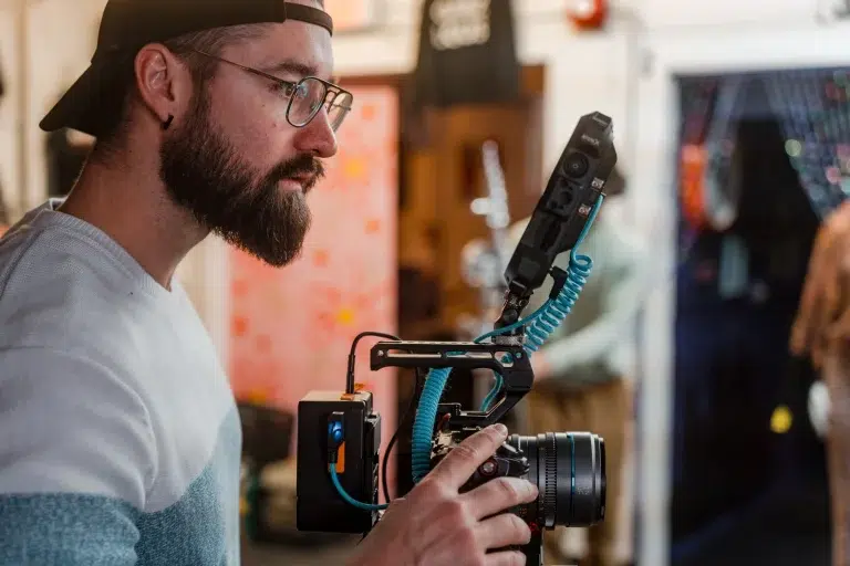 A videographer holds a camera while on set of a video shoot in Calgary.